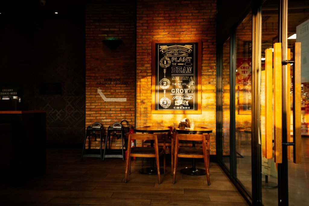 Warm and inviting coffee shop interior with sunlight and stylish design.