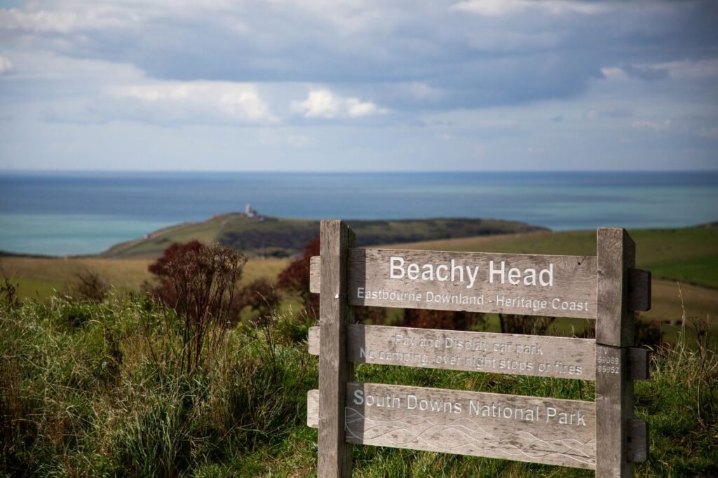 Wooden sign at Beachy Head overlooking the sea at South Downs National Park, England.