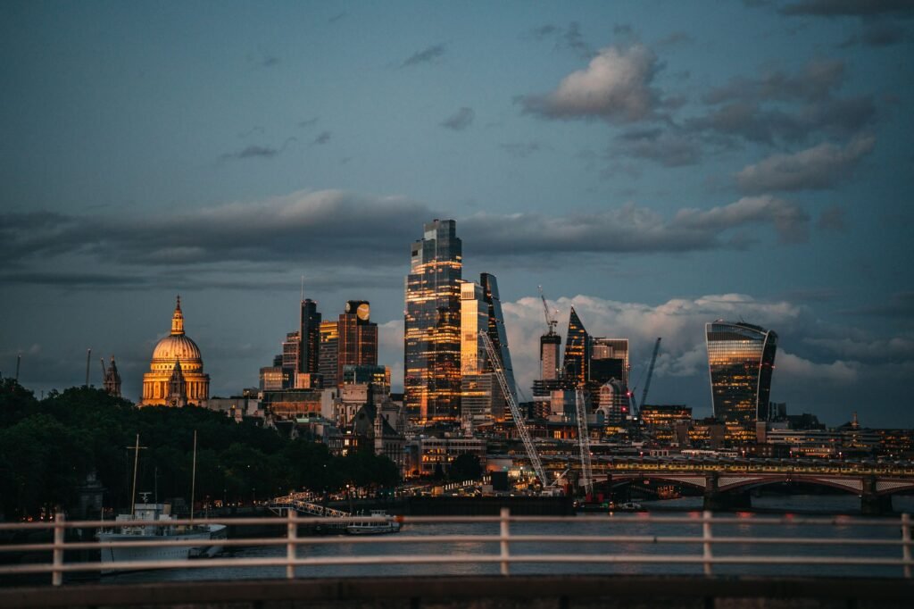 Capture of London's skyline at sunset showcasing modern skyscrapers and historic landmarks.
