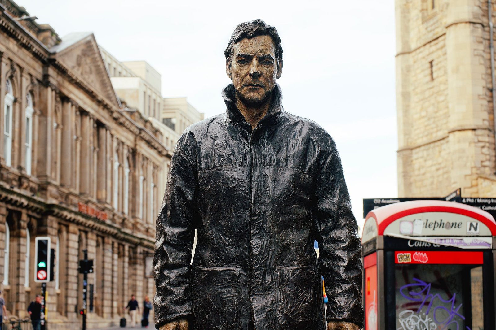 Bronze statue with city backdrop in Newcastle, England.