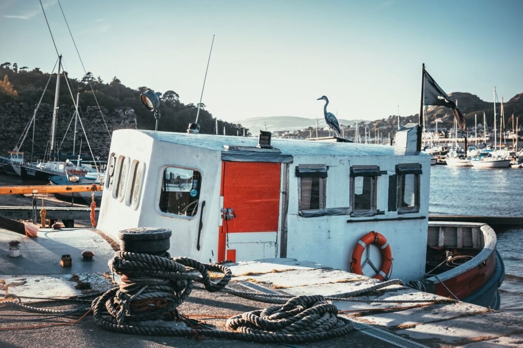 A serene view of fishing boats docked in Conwy Harbor, Wales.