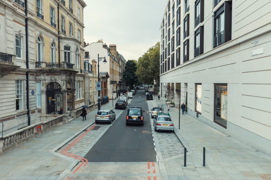 Elegant street scene featuring classic and modern architecture in a vibrant city.