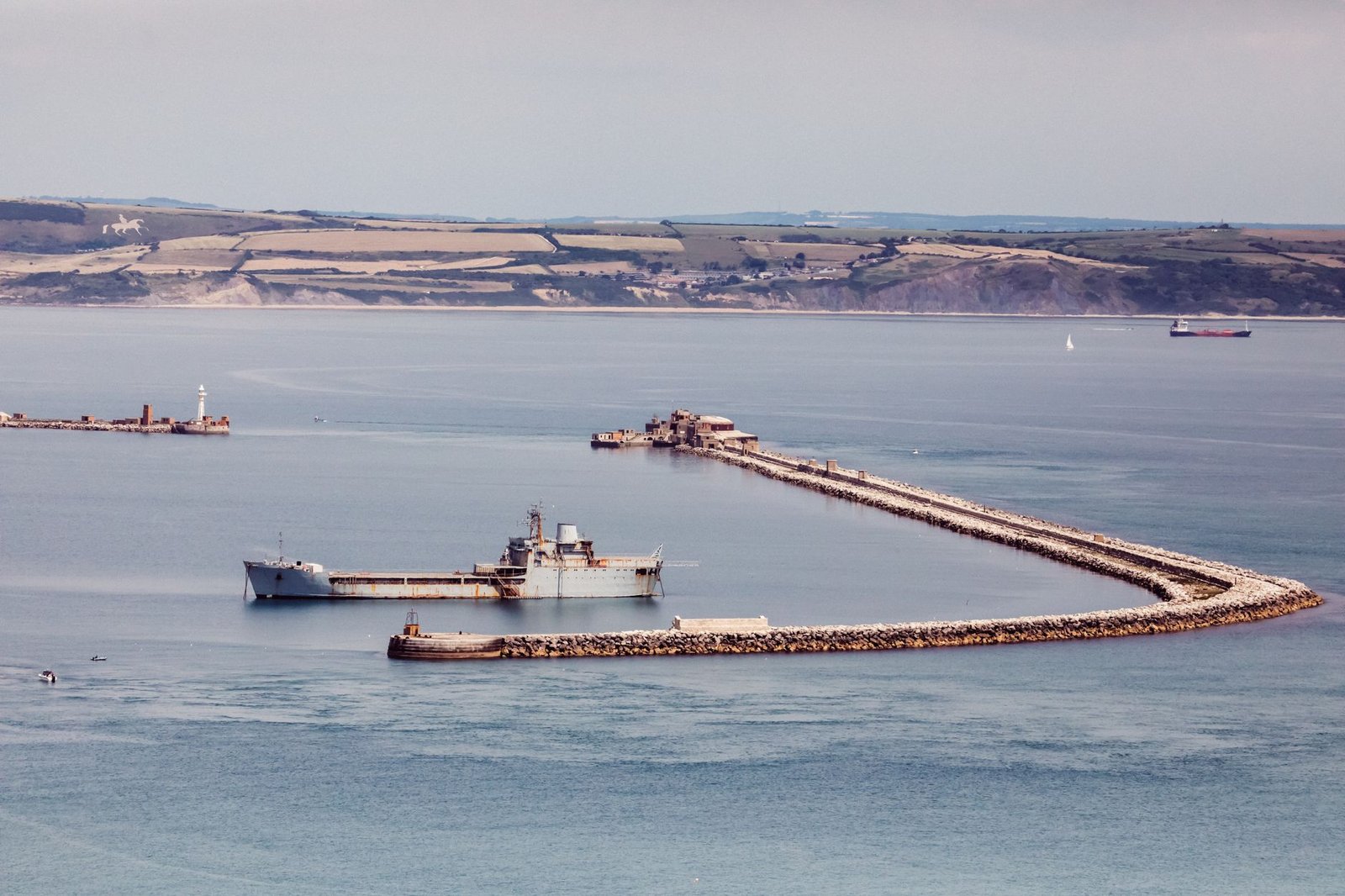 A panoramic view of Portland Harbour featuring ships and the iconic pier in England.