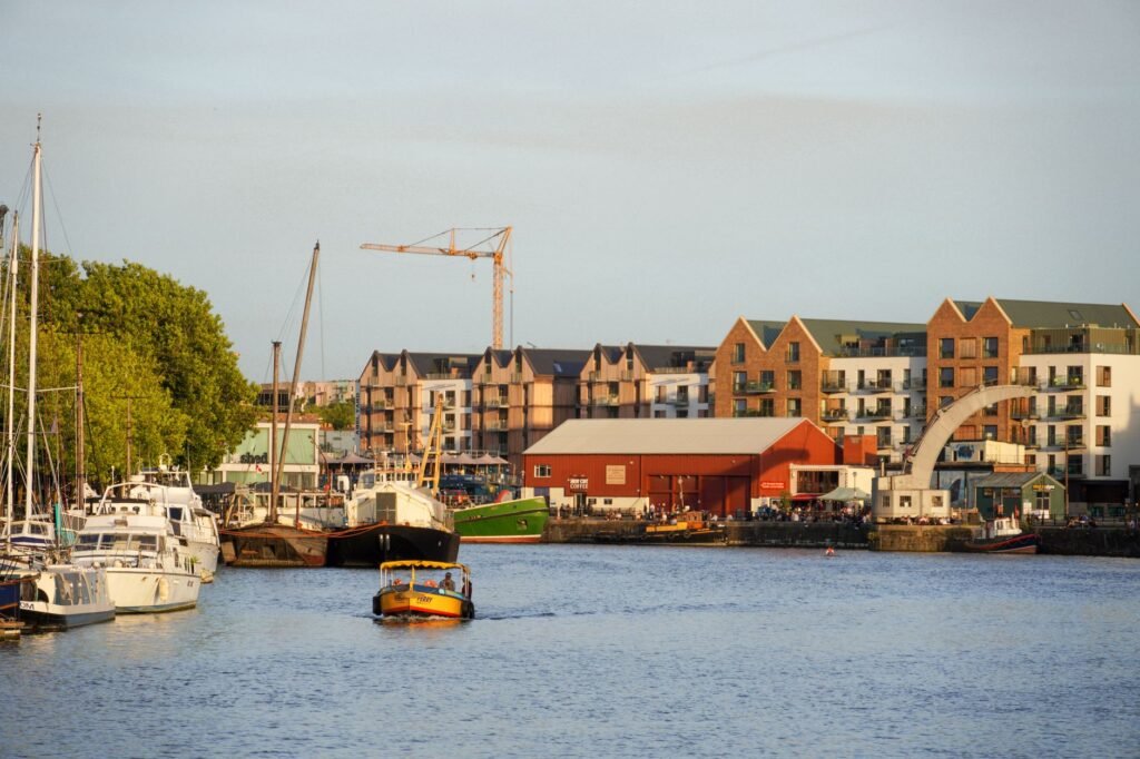 Charming urban waterfront with boats and buildings captured at sunset, creating a serene atmosphere.