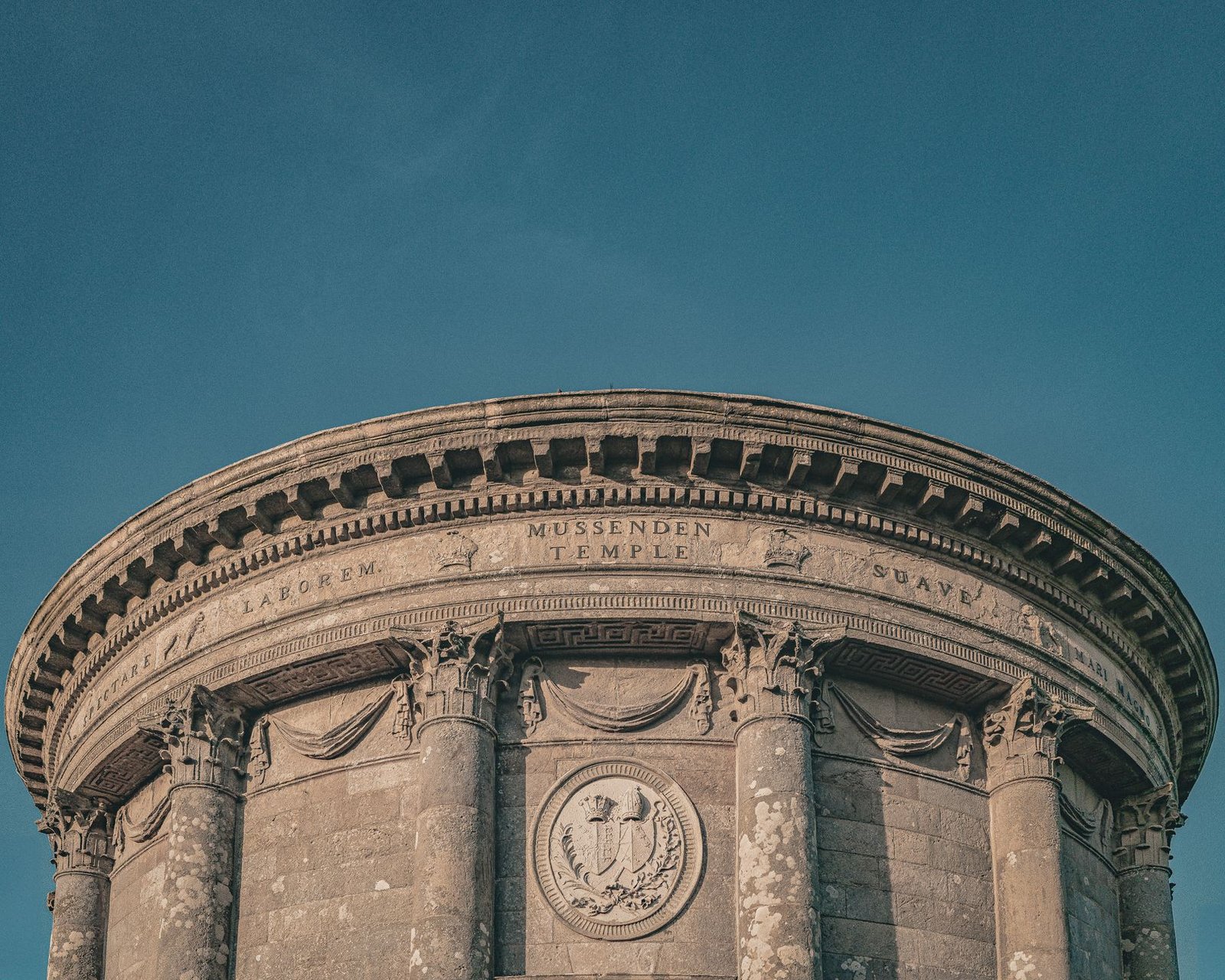Mussenden Temple's stunning neoclassical architecture under a clear blue sky.