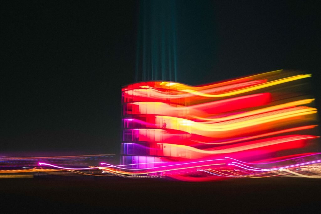 Vibrant abstract urban scene showing blurred multi-colored lights at night.