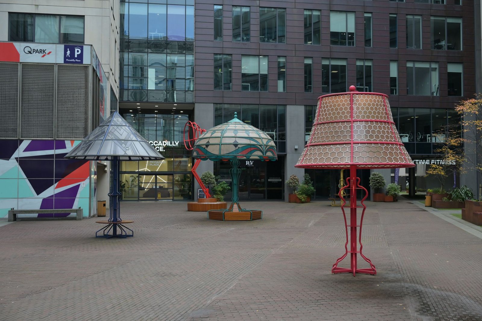 Colorful modern sculptures in an urban courtyard provide an artistic city scene.