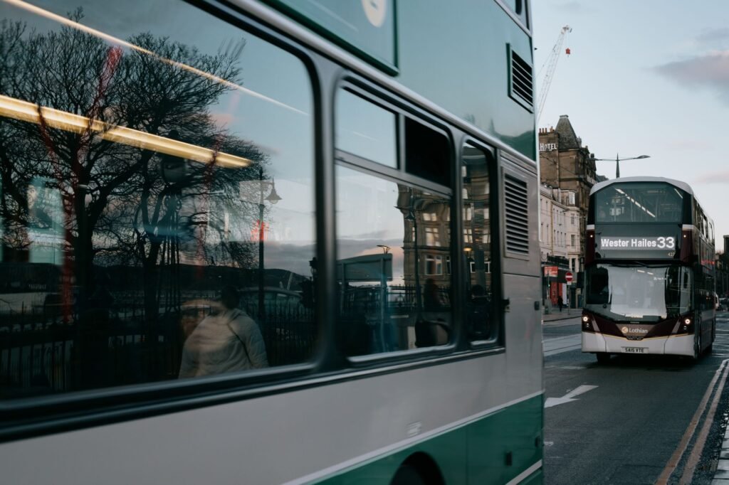 Double-decker buses in Edinburgh with reflections on a winter day.
