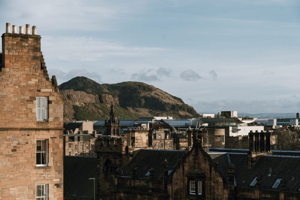 Scenic view of Edinburgh's historic skyline with Arthur's Seat in the background.