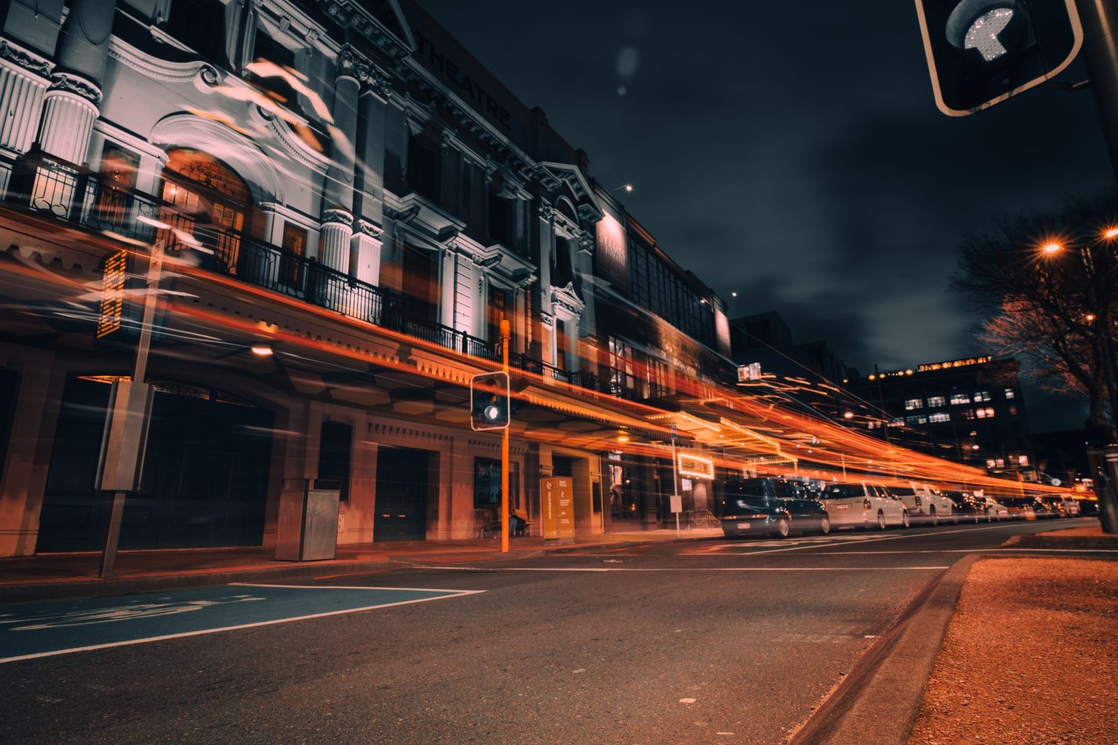 Vibrant city life in Wellington captured with stunning light trails on a bustling street at night.