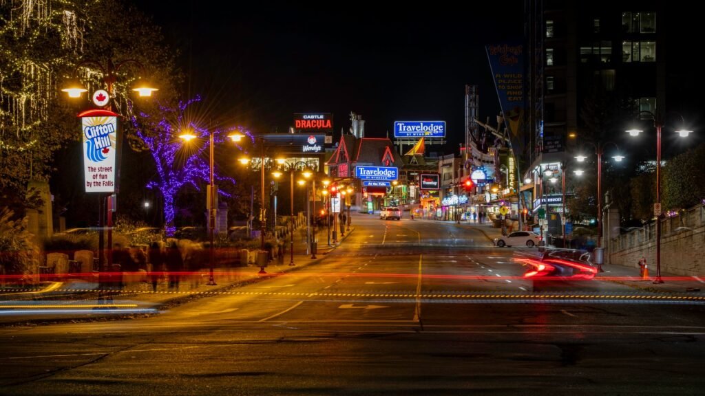 The bustling streets of Clifton Hill lit up at night in Niagara Falls, showcasing vibrant nightlife.
