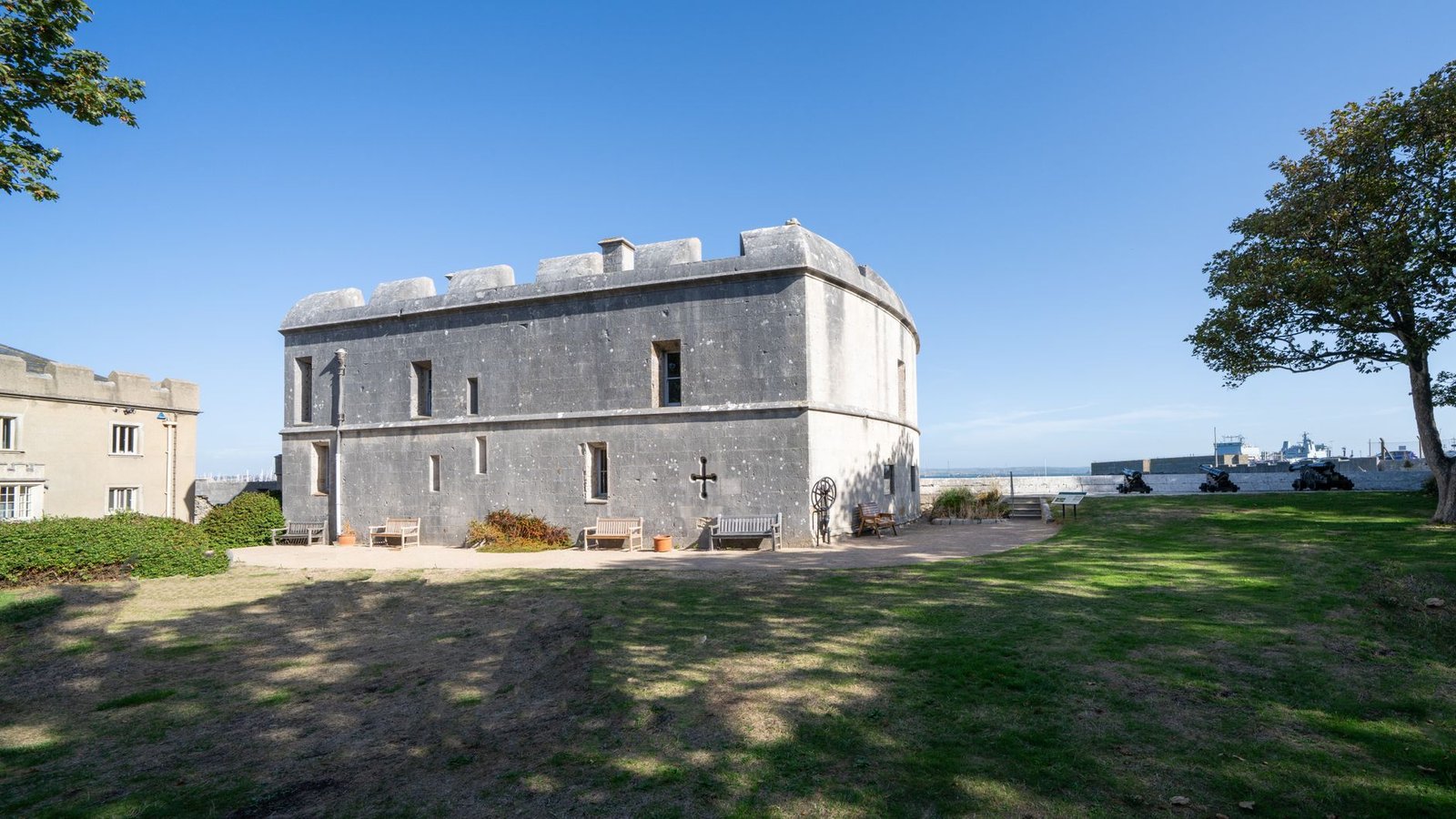 Stone castle fort in Castletown, England under clear blue sky.