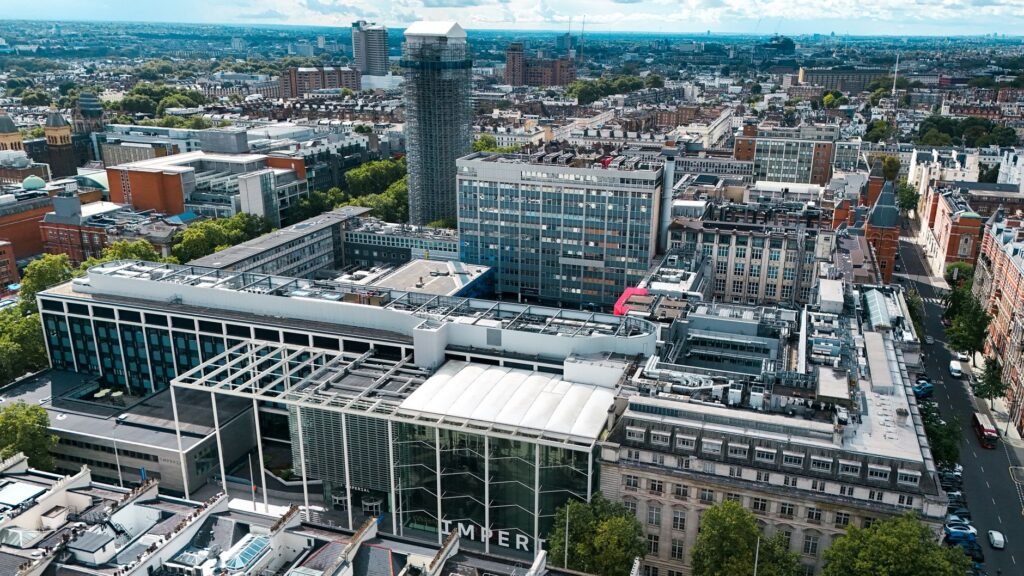 Aerial cityscape of modern architecture in London, England with clear skies.