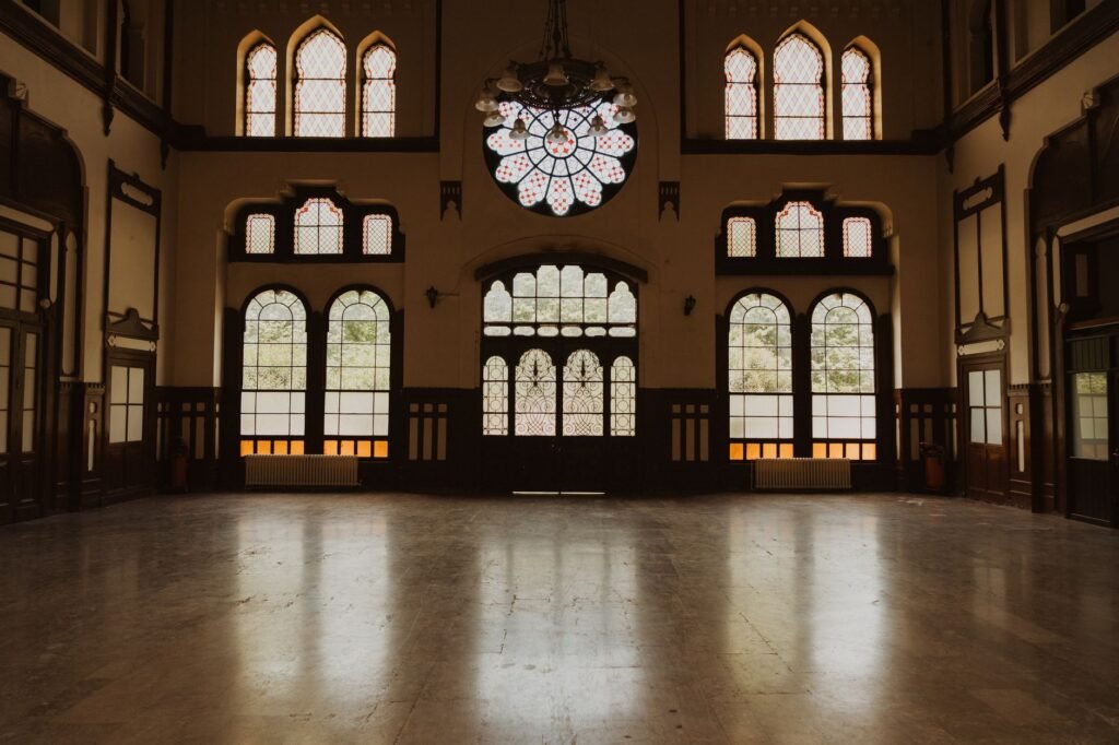 Elegant interior of historic Sirkeci Station, Istanbul with arched windows and chandelier.