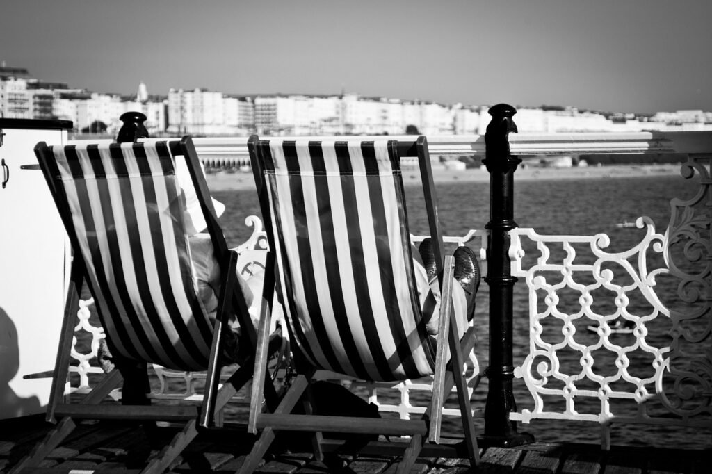 brighton pier, old couple, black and white, deck chairs