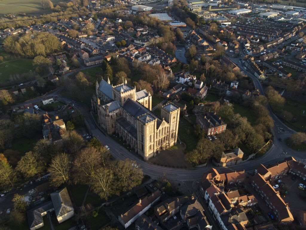 Stunning aerial view of a historic cathedral surrounded by a scenic townscape.