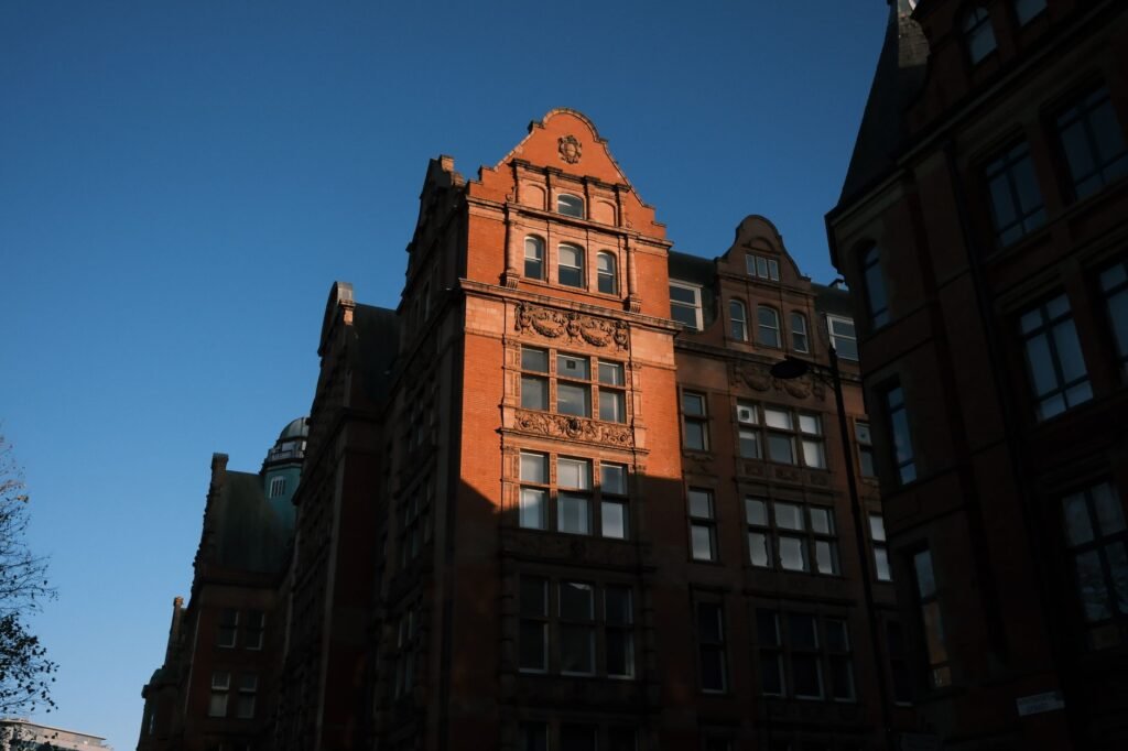 A historic brick building in the city highlighted against a clear blue sky.