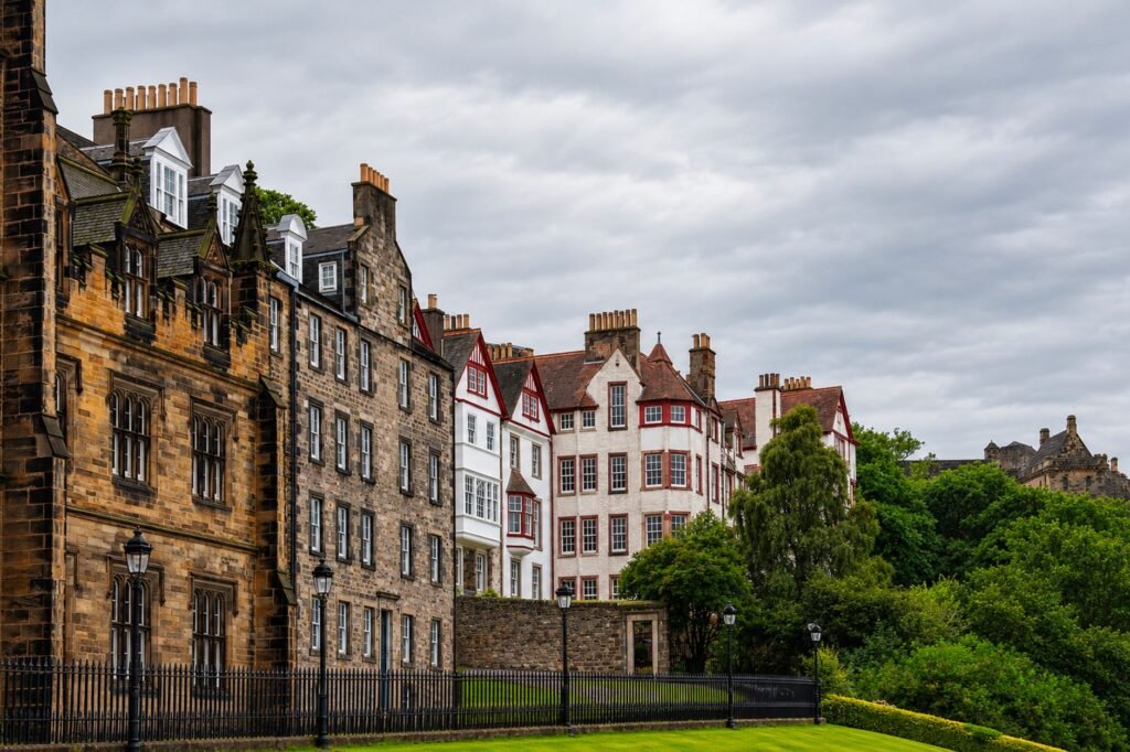Charming view of historic buildings in Edinburgh's Old Town with lush greenery.