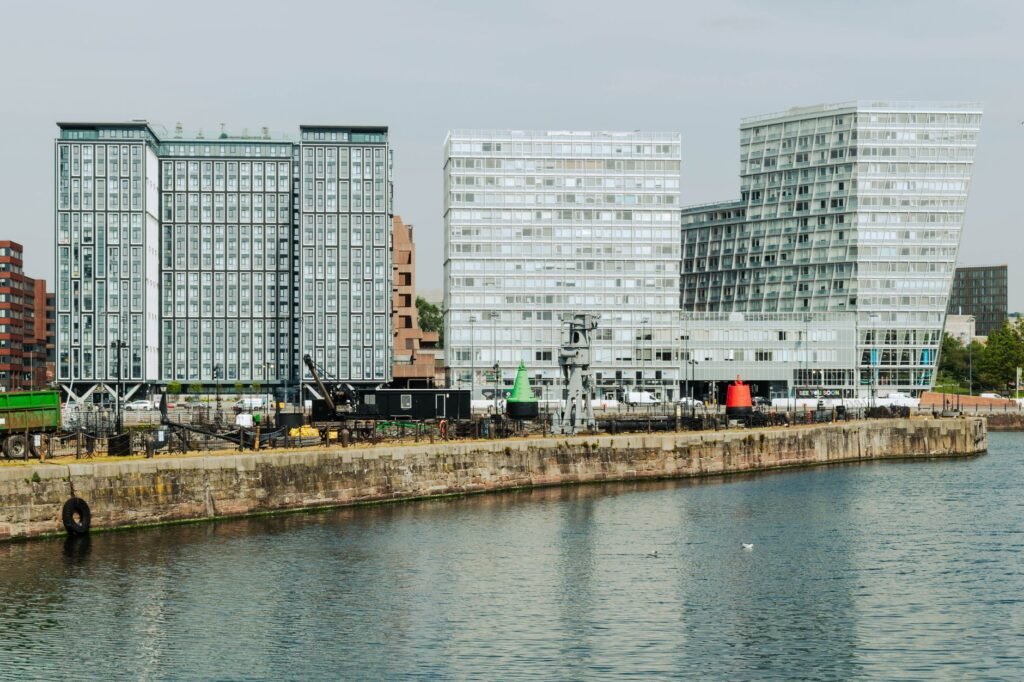 Contemporary buildings reflecting on the water in Liverpool, England.