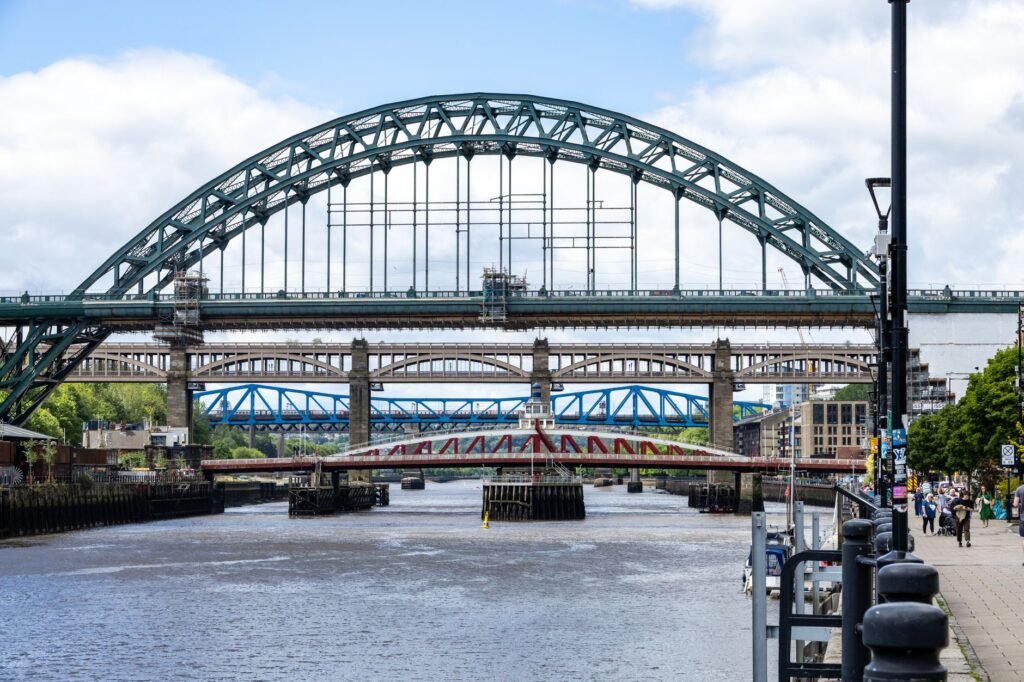 The Tyne Bridge view showcasing multiple iconic bridges over the River Tyne on a sunny day.