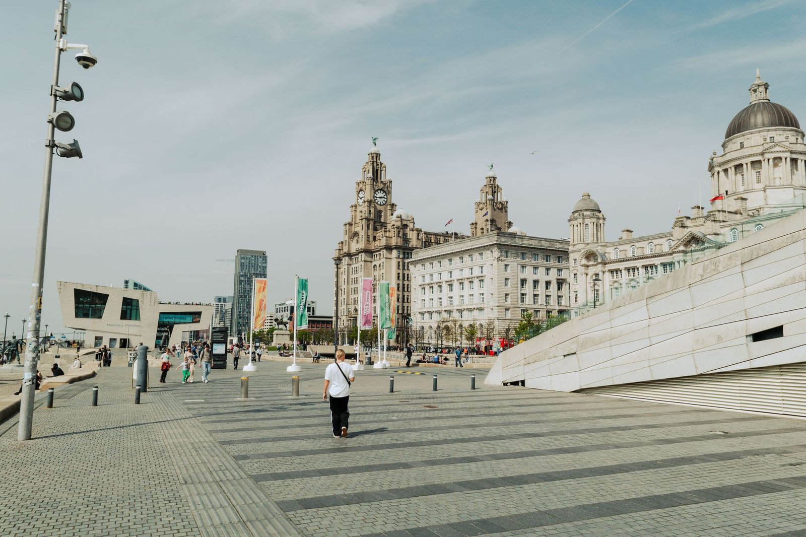 Daytime view of iconic buildings in Liverpool, England, showcasing urban life and historic architecture.