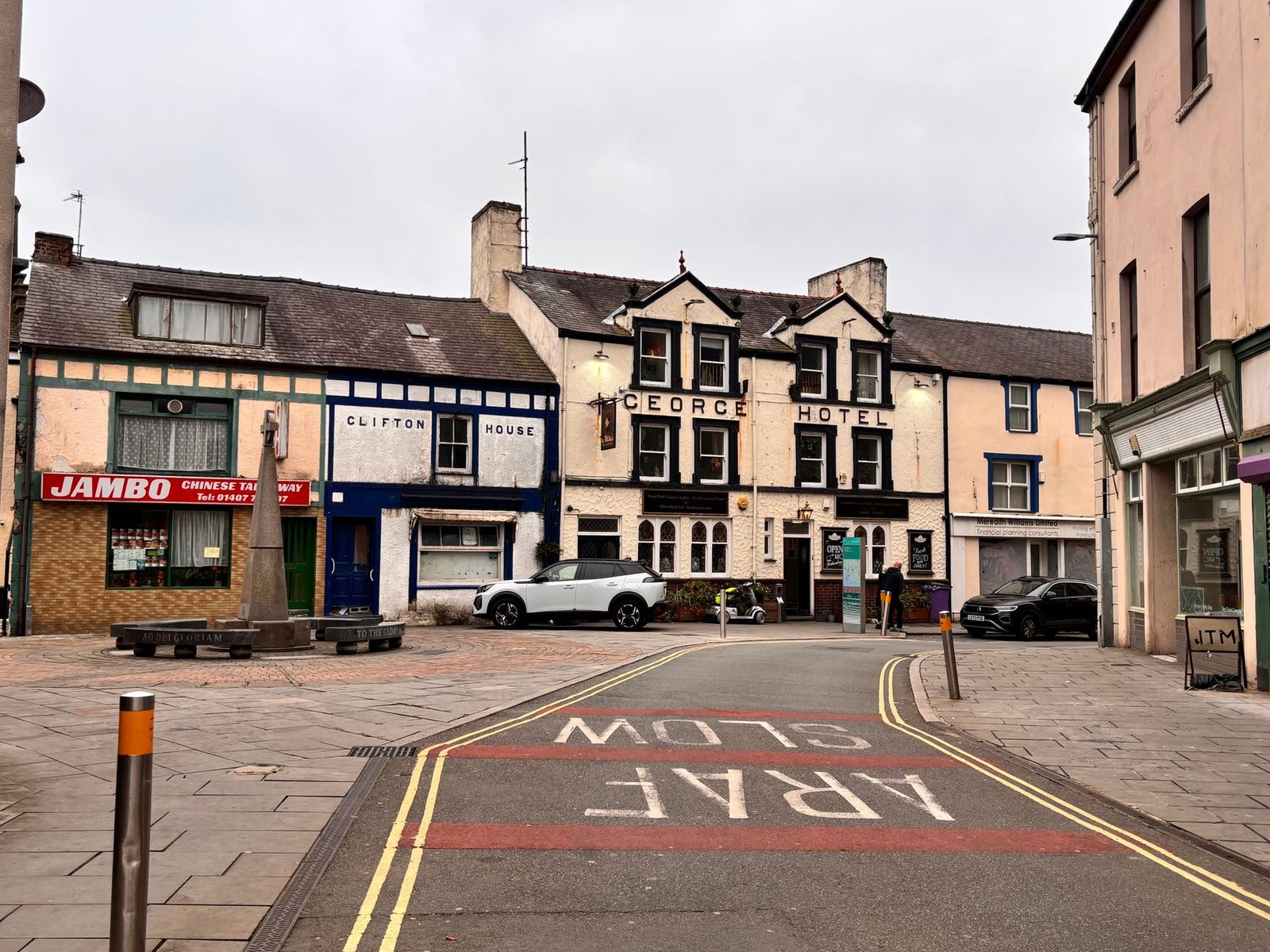 Quaint street scene with historical buildings and classic hotel, perfect for travel content.