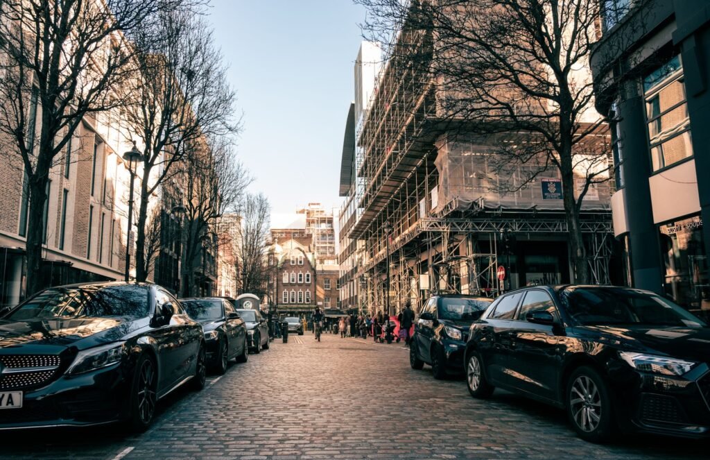 Captivating urban scene in London showcasing architecture and parked cars on a cobblestone street.