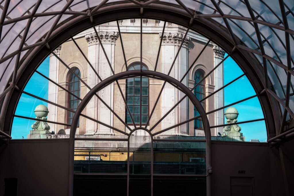 Dramatic view of classical architecture through a glass atrium in London, UK.