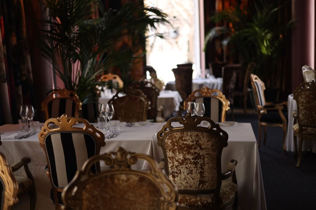 A luxurious restaurant interior featuring elegant chairs and tables set for dining, exuding sophistication.