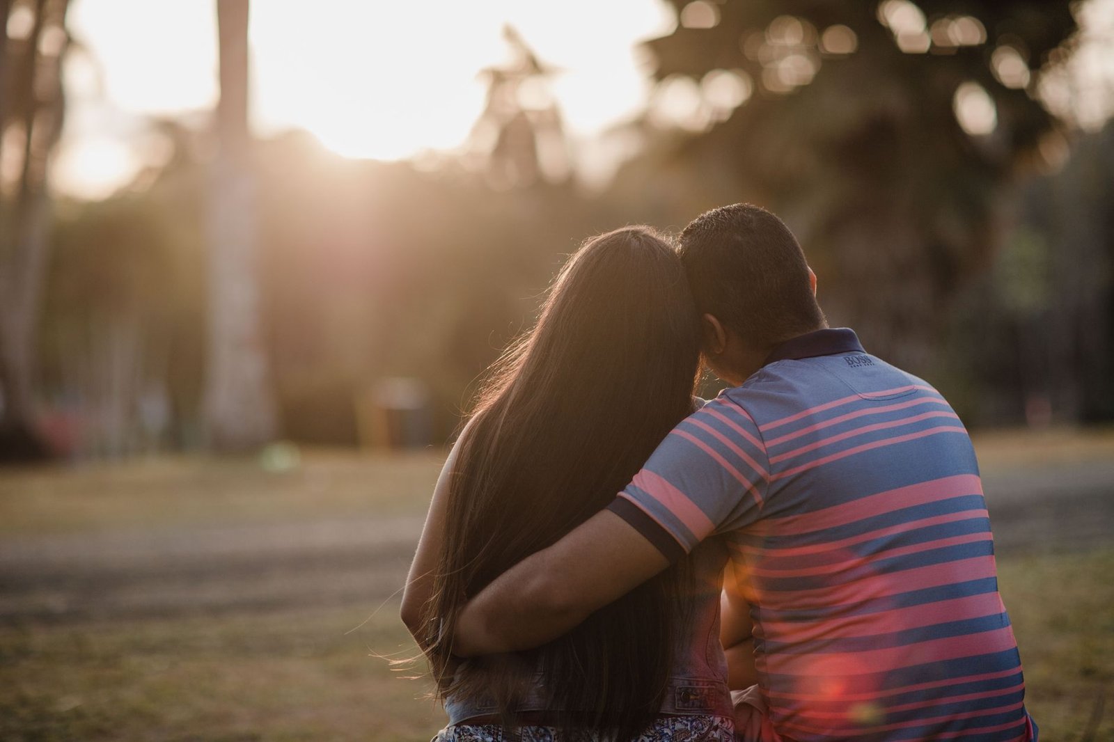 A couple enjoys a romantic sunset in a park in Panama, showcasing love and connection.