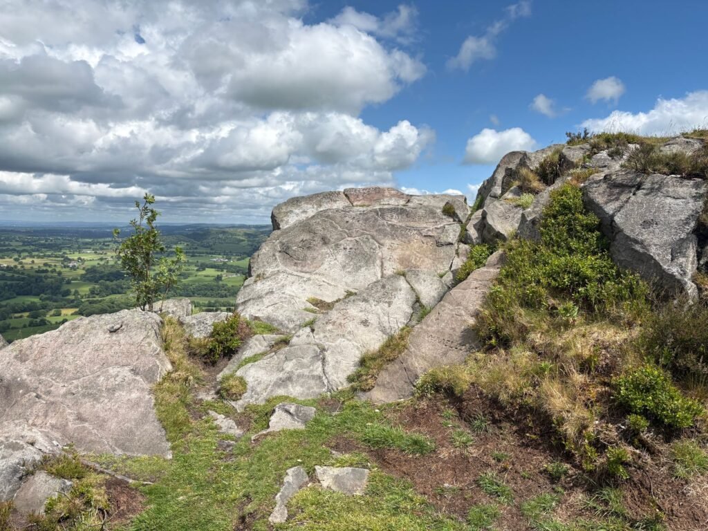 Breathtaking landscape view from a rocky outcrop in a natural park setting in England.