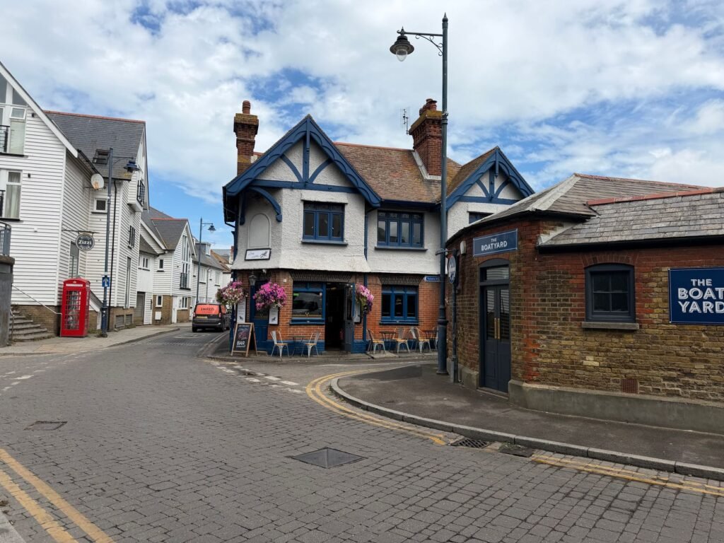 Idyllic street scene in Whitstable, showcasing historic architecture and cozy cafes.