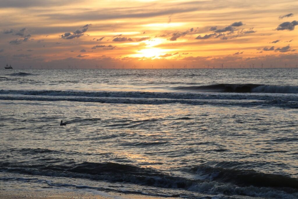 Stunning sunset view over the North Sea from the coast of Zuid-Holland, Netherlands.