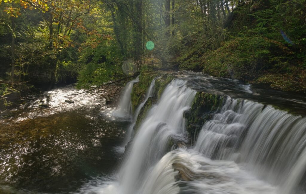 Scenic waterfall in Brecon Beacons National Park, Wales, during autumn.