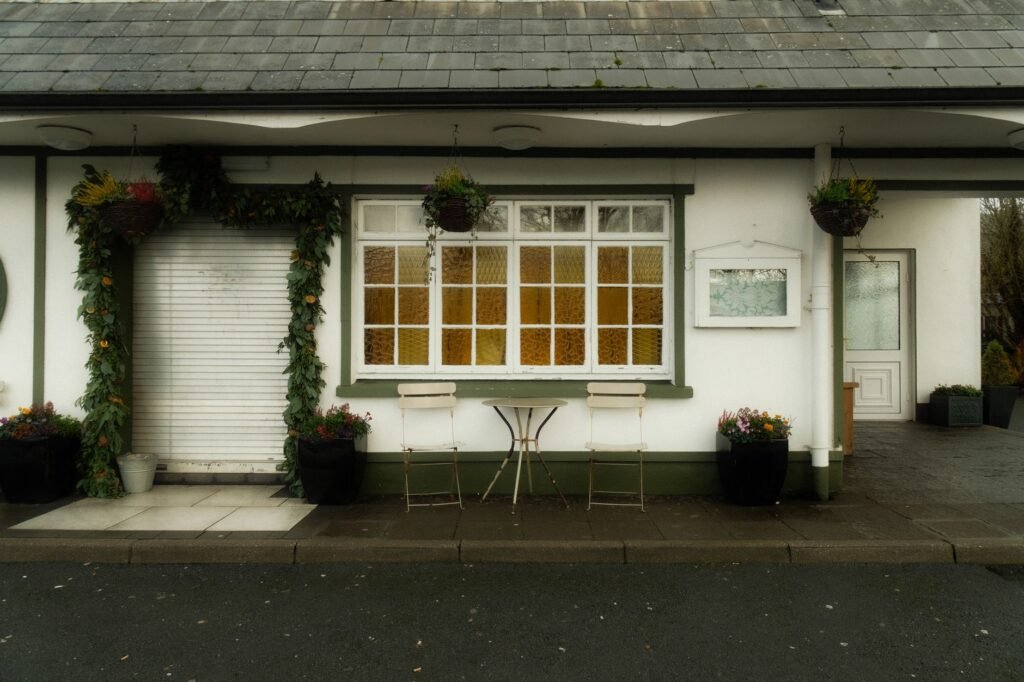 Charming outdoor café with floral decor and vintage furniture, perfect for a peaceful retreat.