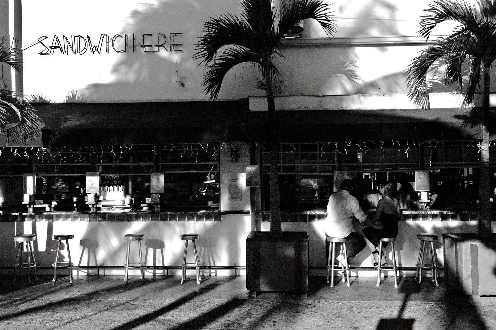 Couple enjoys a meal at a chic outdoor café on Miami Beach, Florida.