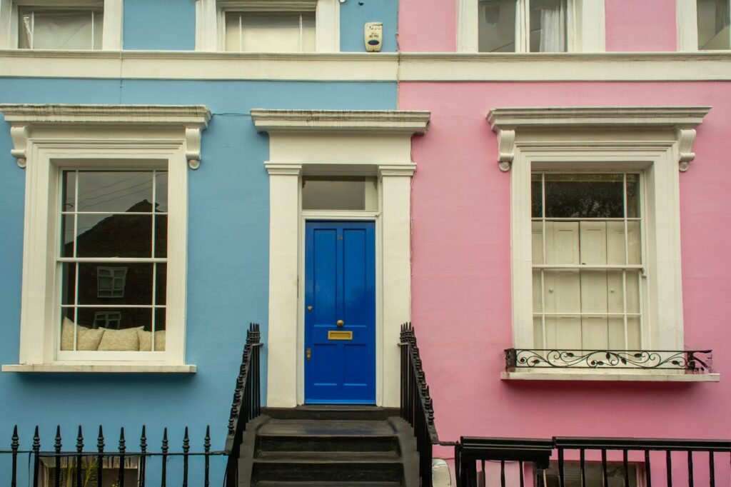 Vibrant blue and pink facade of a Georgian-style townhouse in London.