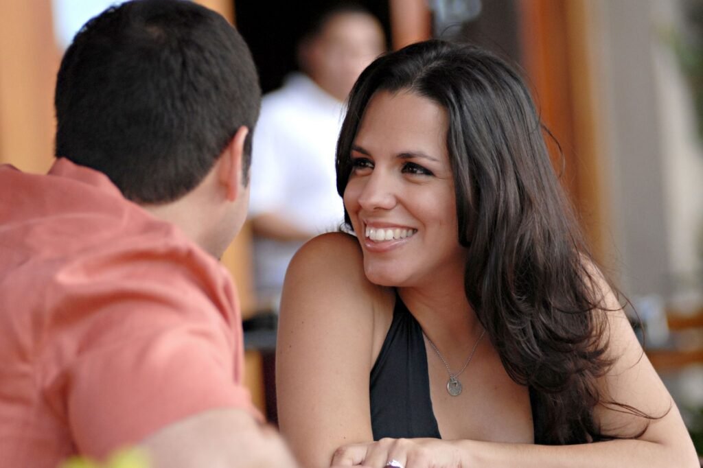 A joyful interaction between a couple at an outdoor café in Miami Beach, Florida.