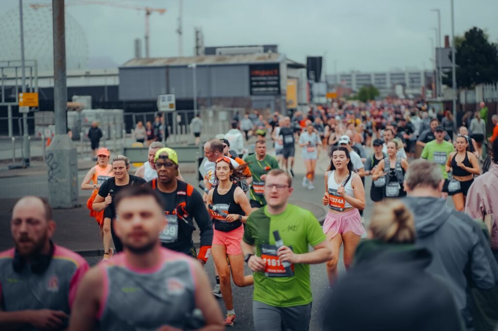 Energetic scene of marathon runners racing through the streets of Belfast, Northern Ireland.
