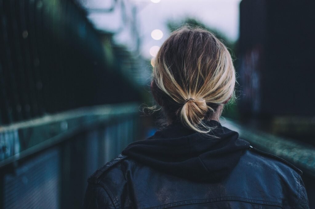 adult, back view, blonde hair, black leather jacket, bridge, girl, woman, urban, walking, commuting, bridge, walking, walking