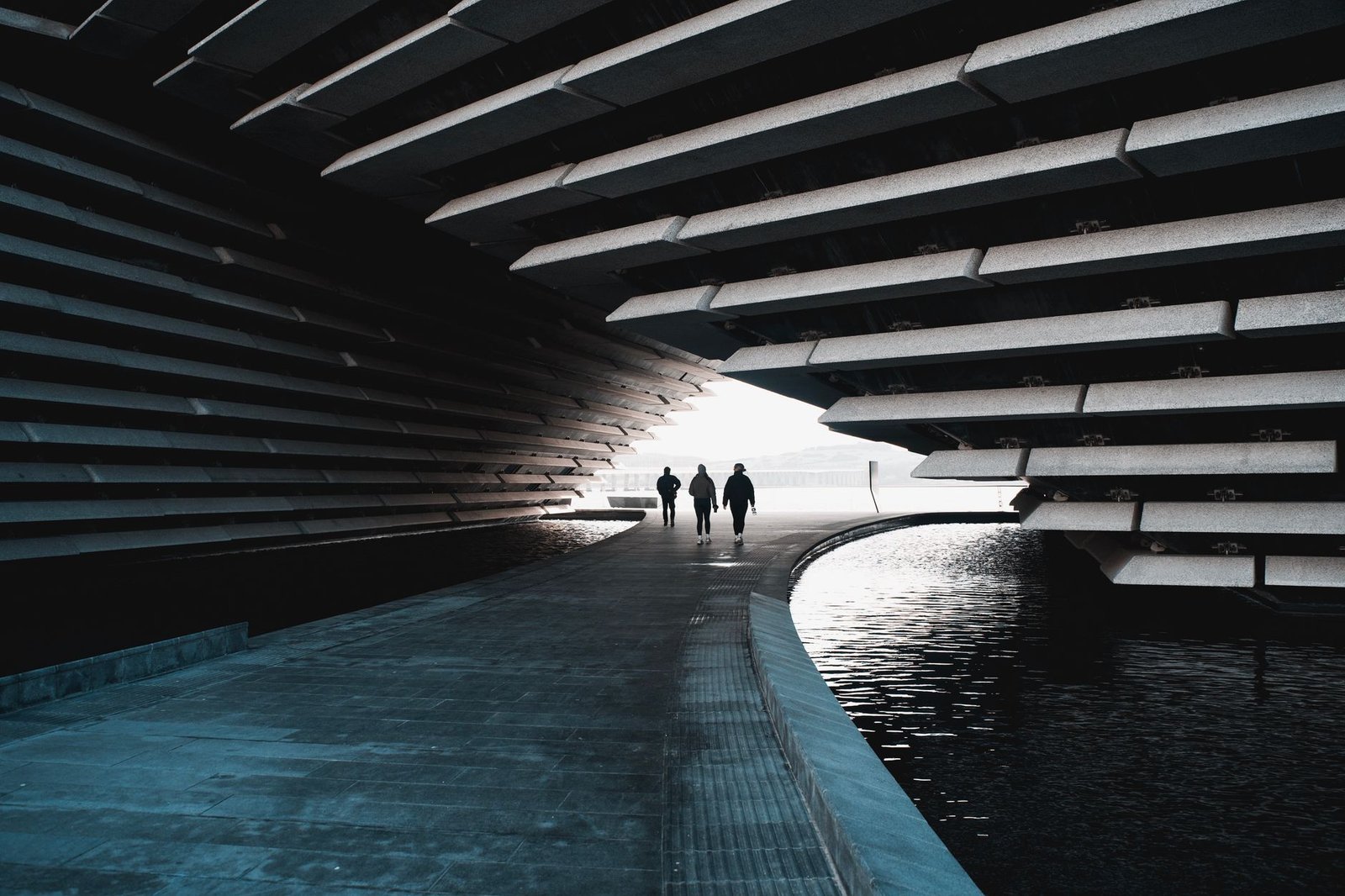 Dramatic view of modern architecture at V&A Dundee Museum in Scotland, showcasing striking lines and reflection.