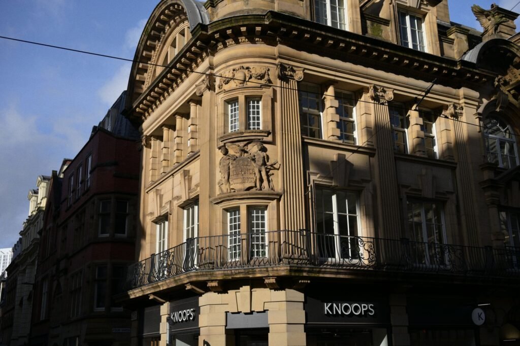 Close-up of an ornately designed historic building facade illuminated by sunlight.