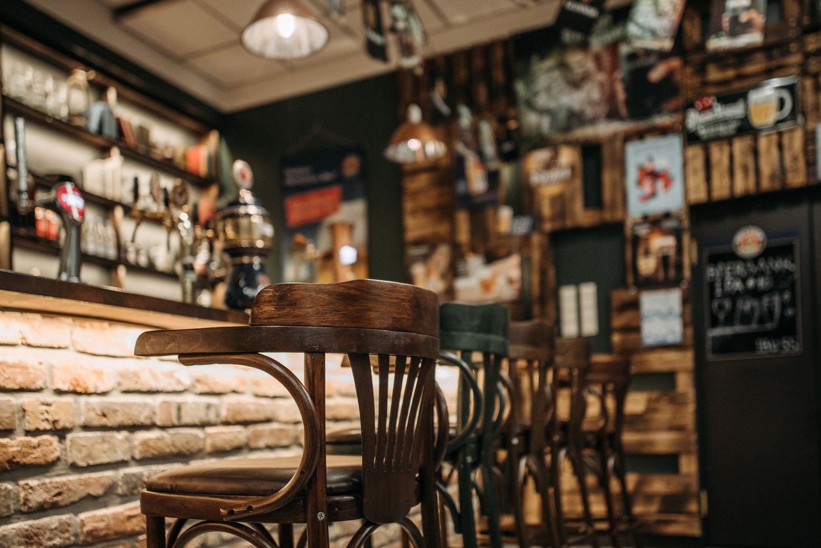 Warm, inviting pub interior featuring rustic wooden chairs in a laid-back setting.