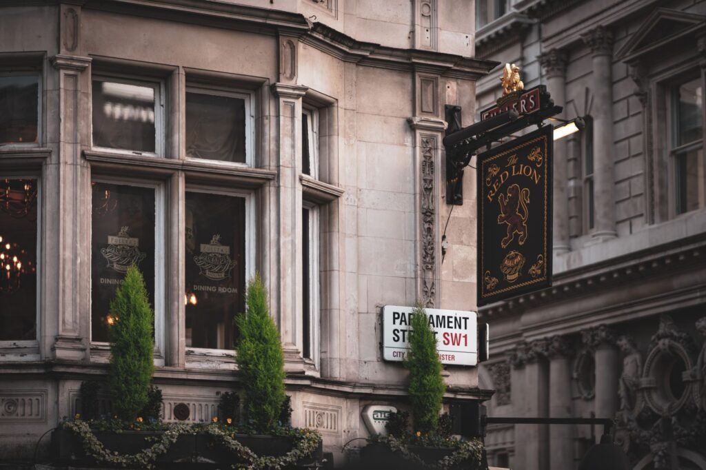 A traditional pub facade in London showcases classic architecture with detailed signage.