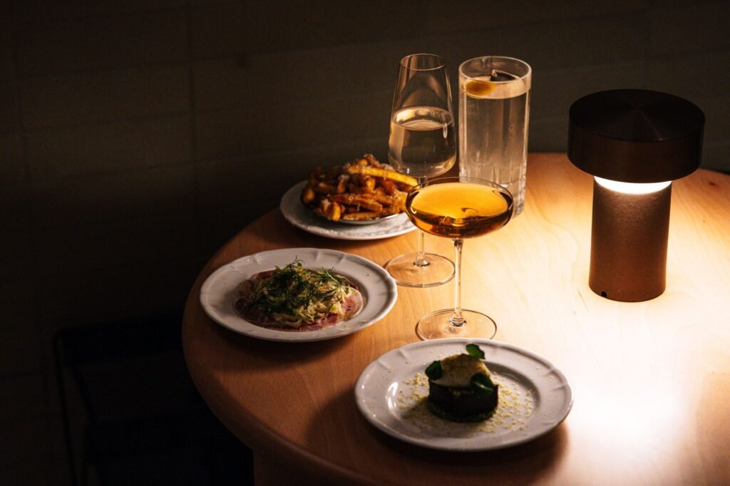 Sophisticated dining setup with gourmet dishes and drinks in Tokyo restaurant.