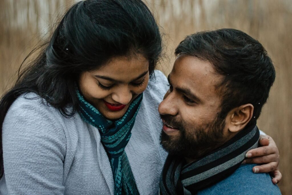 A couple sharing a tender moment outdoors, showcasing love and affection.