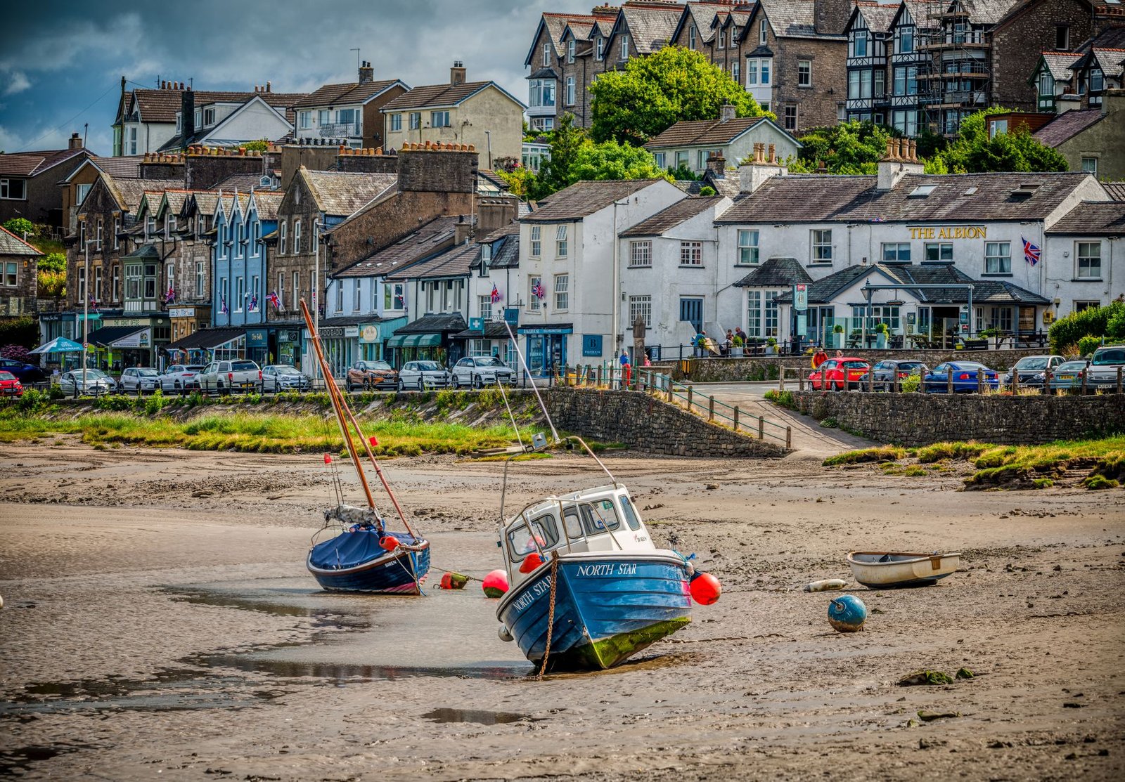 A picturesque view of Arnside's coastal area with boats and historic architecture.