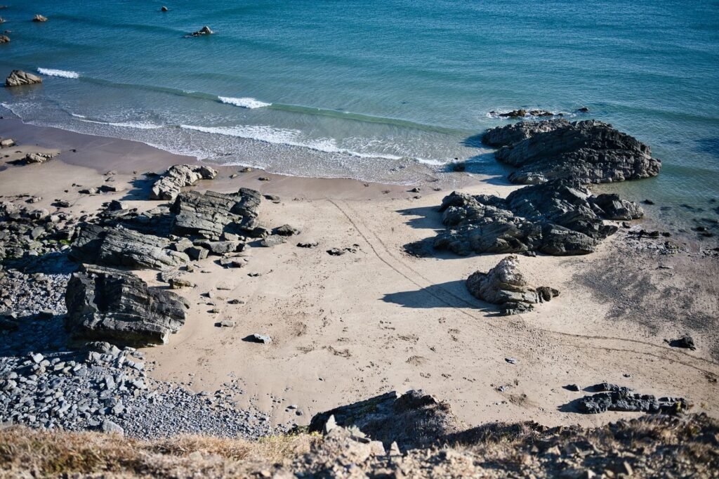 Aerial view of a rocky beach in Wales, showcasing natural beauty and serene ocean waves.