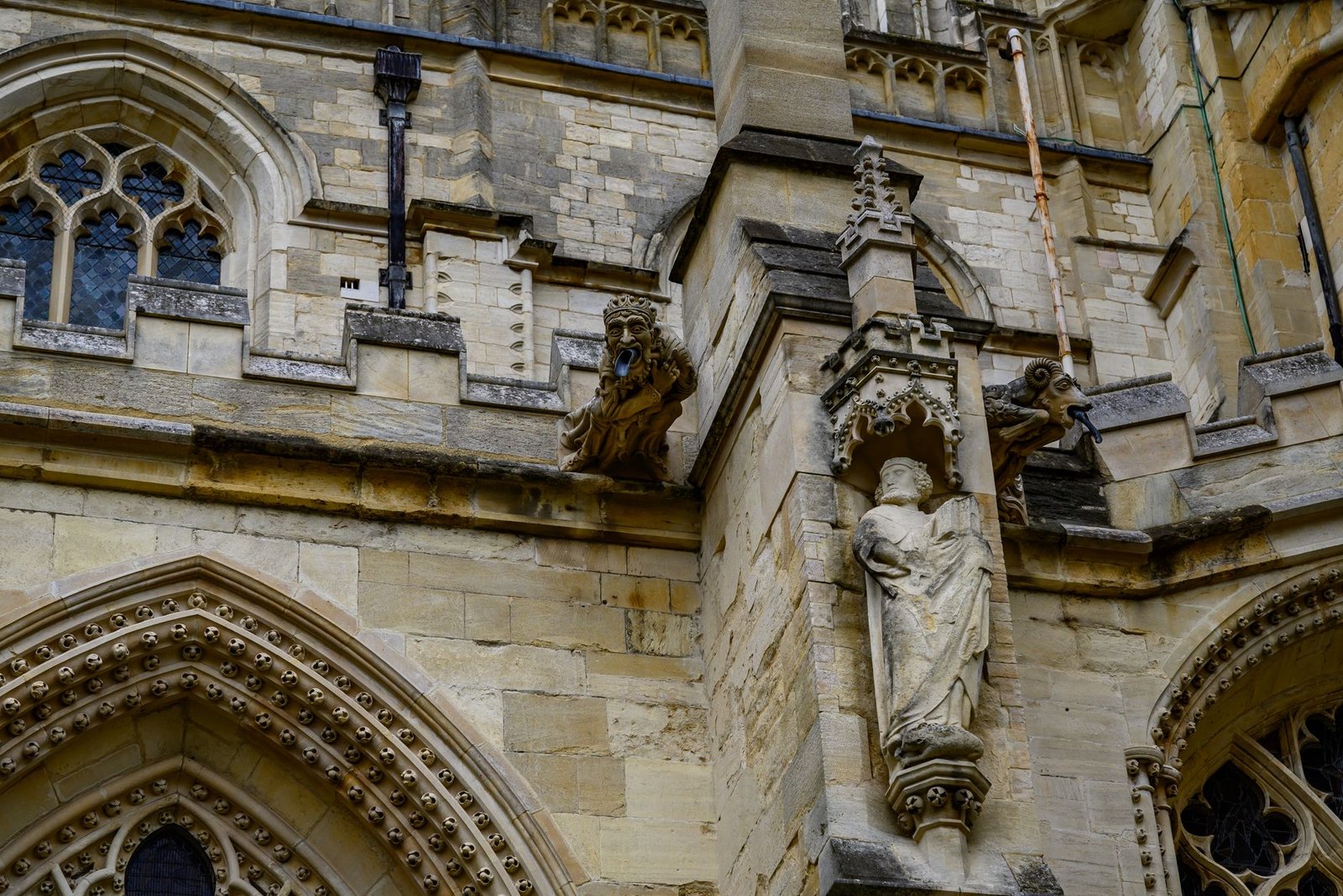 Close-up of Gothic architecture featuring statues and gargoyles in England.