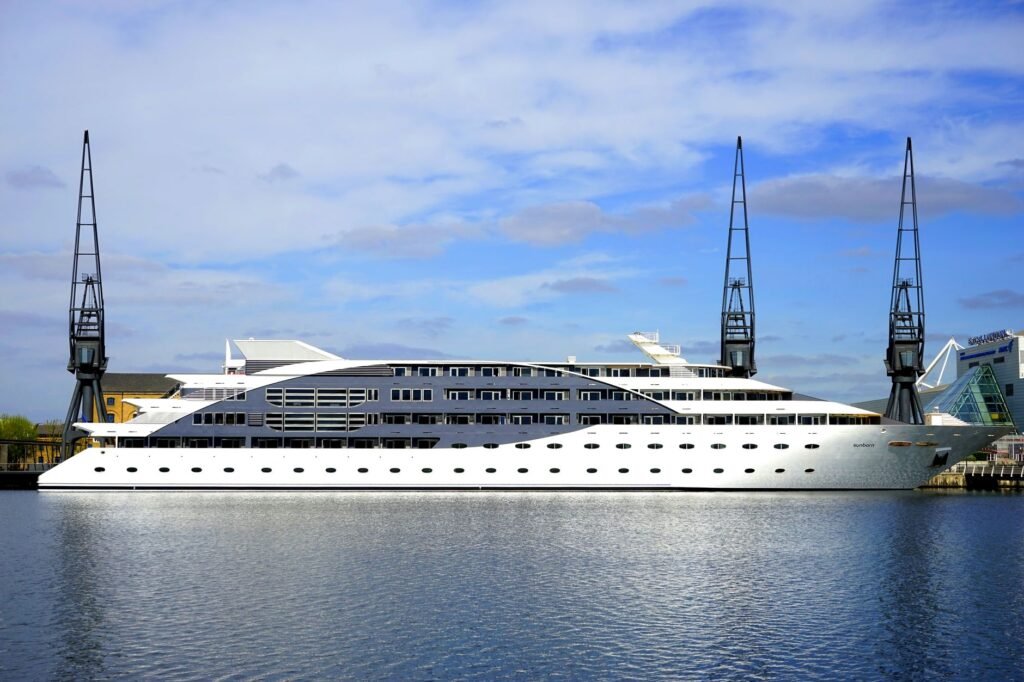 Stunning view of a luxury cruise ship docked at a modern harbor under a blue sky.